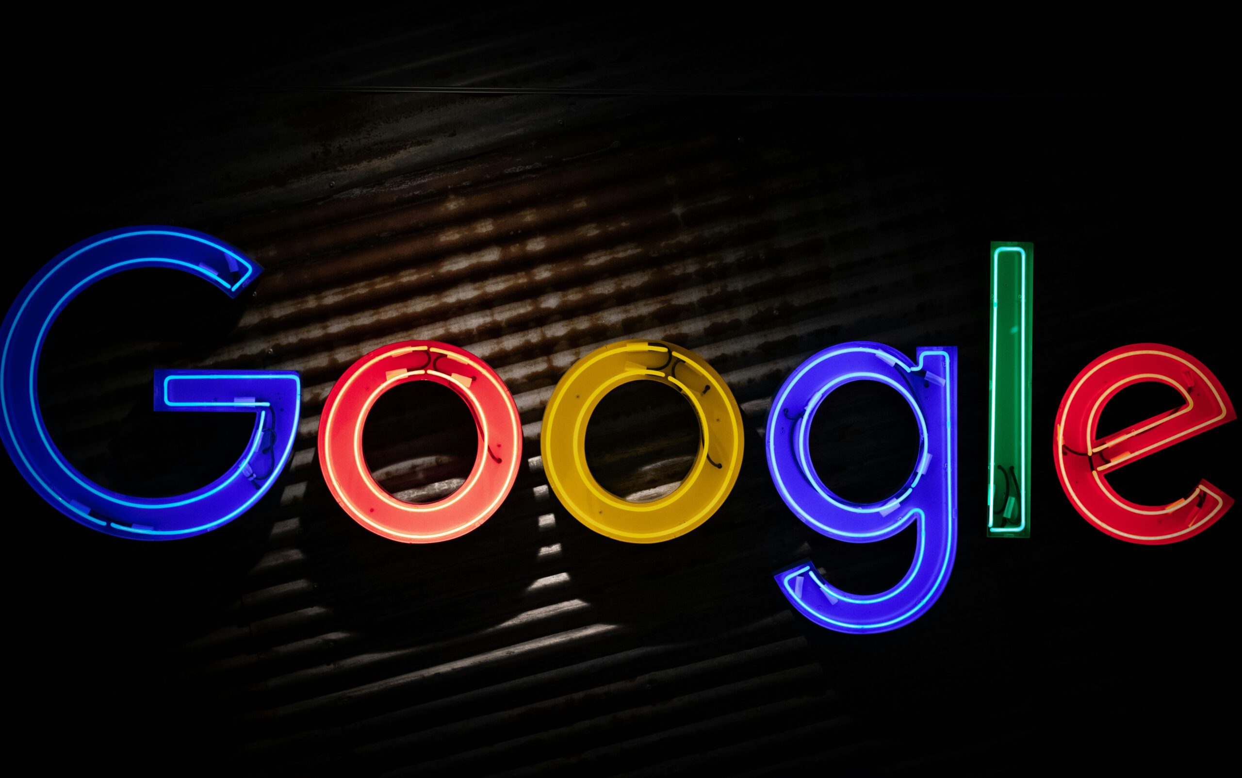 Google logo glowing in digital neon style on a dark background symbolizing search engine dominance.